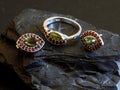 Women's jewelry set earrings in eye shape and ring with Czech red garnet and green moldavit or vltavin gemstone Royalty Free Stock Photo