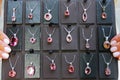 Women`s jewelry silver neck pendants with precious stones on a black background