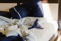 Women`s lace blue panties on a crumpled bed. Morning after a hot night. Background for sexual concept