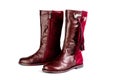 Women`s leather boots in burgundy, fastened with a zipper. Background for women`s shoes