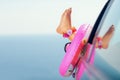 Women's legs against blue sea and sky background,from the car Royalty Free Stock Photo