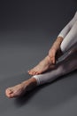 Women`s legs. Bare feet. On the feet of a vein Legs folded in an unusual way. On the legs are white leggings