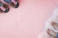 Women`s legs and slippers on different sides on a soft fluffy pink background