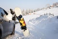 Women,s legs in snowboard from the car near beauty view of mountains and christmas trees in winter Royalty Free Stock Photo