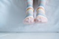 Women`s legs in socks colors alternating, side stand on white fabric floor. Royalty Free Stock Photo