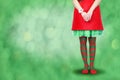 Women`s legs in striped stockings stand on a red Christmas background Royalty Free Stock Photo