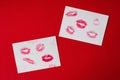 Women`s lips lipstick kiss print set for Valentine`s Day and love collection on white paper on red . The shape of the lip makeup