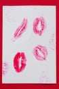 Women`s lips lipstick kiss print set for Valentine`s Day and love collection on white paper on red . The shape of the lip makeup