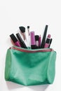 Women`s make-up bag with beauty products. Cosmetics and brushes on white background, View from above. Beauty concept Royalty Free Stock Photo