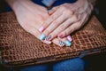 Women's manicure on a background of crocodile skins