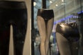 Women`s mannequin shopping mall. Window of clothing store. Dummy of leg. Black clothes of modern style
