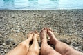 Women`s and men`s feet on beach Royalty Free Stock Photo