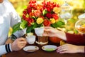 Women's and men's hands with wedding rings with two cups of tea Royalty Free Stock Photo