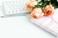 Women`s office desk, female workspace with laptop, flowers roses, accessories, notebooks