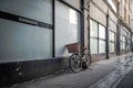 Women`s old style bicycle seen lent up against the side of a shop window. Royalty Free Stock Photo