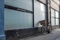 Women`s old style bicycle seen lent up against the side of a shop window. Royalty Free Stock Photo