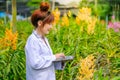 Women`s Orchid Researchers are exploring and documenting the characteristics of orchids in garden