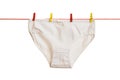 Women`s panties with colorful clothespins on a clothesline. Isolated on a white background. Royalty Free Stock Photo