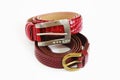 Women`s red leather belts with buckle on white background Royalty Free Stock Photo