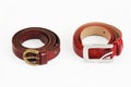 Women`s red leather belts with buckle on white background Royalty Free Stock Photo