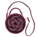 Women`s round leather bag with a long handle decorated with a three strand cord.