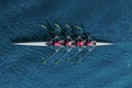 Women`s rowing team on blue water