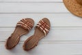 Women`s sandals and hat on a white wooden background. Summer footwear Royalty Free Stock Photo