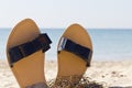 Women sandals on the sandy seashore