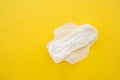 Women's sanitary napkin on a yellow background close-up Royalty Free Stock Photo