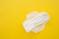 Women's sanitary napkin on a yellow background close-up Royalty Free Stock Photo