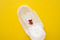 Women's sanitary pad with blood on a yellow background close-up Royalty Free Stock Photo