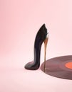 Women's shoe with high-heeled shoes and vinyl on a pastel pink background. Minimal creative abstract visual music art idea. Royalty Free Stock Photo