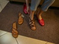 In a women's shoe store, a girl chooses and tries on summer shoes Royalty Free Stock Photo
