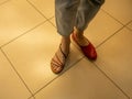 In a women's shoe store, a girl chooses and tries on summer shoes Royalty Free Stock Photo