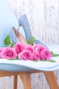 Women`s shoes blue high-heeled. Elegant shoes and a bouquet of roses in the interior. A gift for a girl in the feast of women. Royalty Free Stock Photo