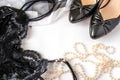 Women`s shoes, shirt, pearl beads on a light background