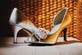 Beautiful silver colour women shoes with jewelry decoration on the cushion with weave wooden background