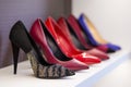 Women's shoes in the store. Shoes of different colors presented on the trading shelf Royalty Free Stock Photo