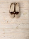 Women`s shoes and sun glasses beige color on a wooden background Royalty Free Stock Photo