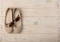 Women`s shoes and sun glasses beige color on a wooden background Royalty Free Stock Photo