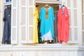 Women`s stylish oriental style ethnic dresses in store at display window, in summer street market. Royalty Free Stock Photo