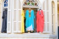 Women`s stylish oriental style ethnic dresses in store at display window, in summer street market. Royalty Free Stock Photo