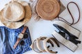 Women`s summer clothes collage on white, flat lay. Woven sandals, rattan bag, hat, watch, shorts, sunglasses top view Royalty Free Stock Photo