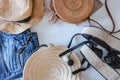 Women`s summer clothes collage on white, flat lay. Woven sandals, rattan bag, hat, watch, shorts, sunglasses top view Royalty Free Stock Photo