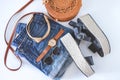 Women`s summer clothes collage on white, flat lay. Woven sandals, rattan bag, watch, shorts, sunglasses top view Royalty Free Stock Photo