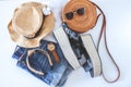 Women`s summer clothes collage on white, flat lay. Woven sandals, rattan bag, hat, watch, shorts, sunglasses top view Royalty Free Stock Photo