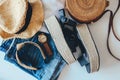 Women`s summer clothes collage on white, flat lay. Woven sandals, rattan bag, hat, watch, shorts, sunglasses top view Royalty Free Stock Photo