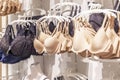 Women's underwear in basic colors on hangers in a store. Comfort and beauty. Side view. Close-up