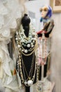 Women`s various pearl necklaces on a mannequin in a jewelry store