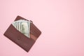 Women`s wallet with money on pink background. Top view Royalty Free Stock Photo